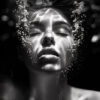 A woman’s face is partially submerged underwater, with closed eyes and bubbles rising around her in a dark, high-contrast setting. Black and white art poster available in A1 to A4 sizes.