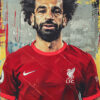 Male soccer player Mohamed Salah, with curly hair and a beard, wears a red Liverpool FC soccer jersey, standing against an abstract, colourful background. Wall art print available in A1 to A4 sizes.