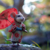 A mouse wearing a floral kimono holds a red parasol, standing outdoors with blurred greenery and flowers in the background. Cute Geisha mouse poster available in A1 to A4 sizes.