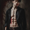 A male vampire with tousled hair wearing an open black shirt stands against a dark background, with fake blood on his mouth and torso, suggesting a vampire or dramatic injury theme. Fantasy art poster available in A1 to A4 sizes.