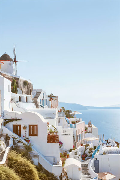 Whitewashed buildings with blue accents on a hillside overlook the sea under a clear sky in Santorini, Greece; a windmill is visible in the background. Nature and landscape print available in A1 to A4 sizes.