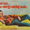 A man reclines on a couch, smiling, with text above him that reads "I'm not lazy, I'm on energy-saving mode." Funny poster available in A1 to A4 sizes.