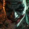 Close-up of The Joker from Batman wearing dramatic clown makeup with dark eyes and a sinister grin, surrounded by smoke and glowing embers, illuminated by moody lighting. Fantasy art poster available in A1 to A4 sizes.