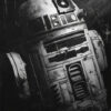 Black and white image of a weathered R2-D2 droid from Star Wars, shown at an angle with visible scratches and scuffs on its surface—seemingly awaiting C-3PO’s next instruction. Fantasy art poster available in A1 to A4 sizes.