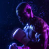A male boxer wearing gloves is captured mid-punch, with water droplets in the air against a dark, dramatic background lit by purple and blue lighting. Poster print available in A1 to A4 sizes.