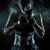 A female boxer wearing black gloves and sportswear stands in a fighting stance, with sweat and water droplets visible against a dark background. Poster print available in A1 to A4 sizes.
