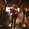 Harley Quinn stands in a dimly lit, abandoned hallway holding a bat over her shoulder. Fantasy art poster available in A1 to A4 sizes.
