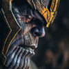 product-image-2-3 A detailed close-up of the Marvel character Thanos with purple skin and a stern expression, wearing a gold helmet and intricate armour. Fantasy art poster available in A1 to A4 sizes.