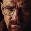 Close-up portrait of a middle-aged man with glasses, moustache, goatee, and furrowed brow in a brown jacket, looking intensely at the camera—Walter White from Breaking Bad. Poster print available in A1 to A4 sizes.