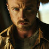 A man with a serious expression stands indoors, wearing a tan jacket over a t-shirt. His face is slightly dirty and he has a short beard and mustache—a portrait reminiscent of Jesse Pinkman from Breaking Bad. Poster print available in A1 to A4 sizes.