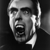 Dracula, with fangs bared and blood dripping from his mouth, is captured in dramatic black and white lighting for a chilling vintage look. Horror poster available in A1 to A4 sizes.