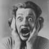 Black and white photo of a woman with wide eyes and mouth open, holding her face in apparent shock or fear. Horror poster available in A1 to A4 sizes.