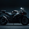 Side view of a sleek black Suzuki GSXR-1000 in a dimly lit studio setting, highlighting its aerodynamic design and modern features. Wall art print available in A1 to A4 sizes.