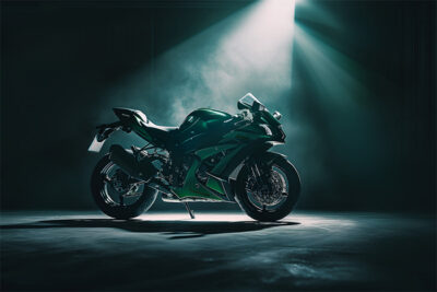 A green Kawasaki ZX10R sport motorcycle is parked in a dimly lit room, illuminated by a single overhead spotlight. Wall art print available in A1 to A4 sizes.