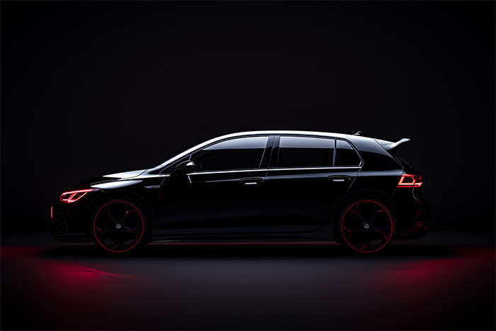 product-image-3-2 A black Volkswagen Golf hatchback viewed in profile against a dark background, with red accent lighting highlighting its outline and wheels. Wall art print available in A1 to A4 sizes.