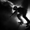 A person wearing a helmet rides a skateboard down a ramp, silhouetted against a bright, smoky background. Wall art print available in A1 to A4 sizes.