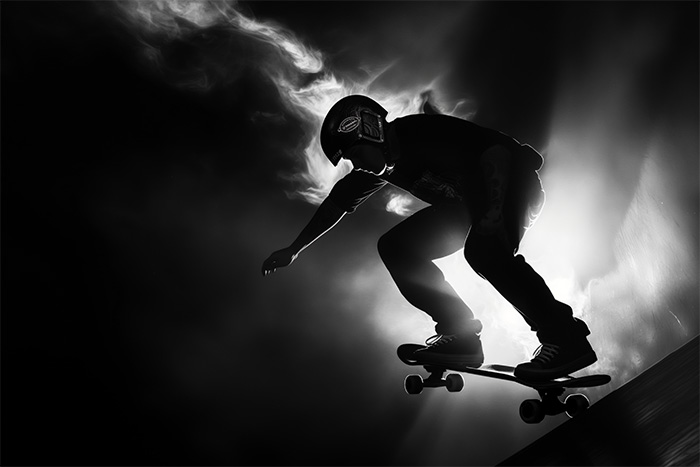 product-image-3-2 A person wearing a helmet rides a skateboard down a ramp, silhouetted against a bright, smoky background. Wall art print available in A1 to A4 sizes.
