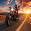 A person wearing a helmet rides a motorcycle on a curving road at sunset, with dramatic clouds and sunlight in the background. Wall art print available in A1 to A4 sizes.
