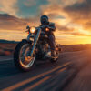 A person rides a motorcycle on a deserted road at sunset, with dramatic clouds and a glowing sky in the background. Wall art print available in A1 to A4 sizes.