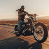 A man with sunglasses and a bandana rides a motorcycle on an open desert road during sunset. Wall art print available in A1 to A4 sizes.