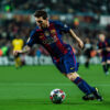 Soccer player Lionel Messi in a blue and red Barcelona uniform runs with the ball on a well-lit field during a match, with spectators visible in the background. Poster print available in A1 to A4 sizes.