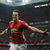 Robin van Persie in a red Manchester United jersey celebrates with arms outstretched on the field, with a full stadium in the background. Poster print available in A1 to A4 sizes.