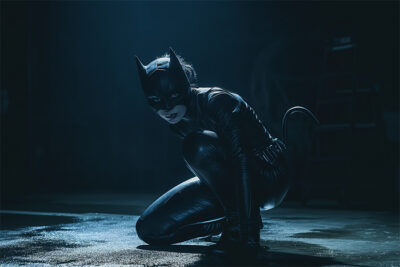 Woman in a black cat costume crouches on the floor in a dimly lit setting with a spotlight highlighting their figure. Fantasy art poster available in A1 to A4 sizes.