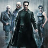 Four characters in dark, futuristic clothing stand before a digital rain backdrop with The Matrix title above them. The central figure, sporting sunglasses and a long coat, wields a weapon—capturing the iconic style of the 1999 science fiction movie. Movie poster print available in A1 to A4 sizes.