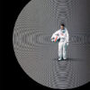 An astronaut in a white suit stands holding a helmet at the centre of concentric white circles, with the word MOON in white text at the bottom. Movie poster print available in A1 to A4 sizes.