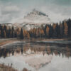 A snow-capped mountain with clouds at its peak is reflected in the calm waters of a Mountain Lake, surrounded by autumn trees and a grassy shoreline. Nature and landscape poster print available in A1 to A4 sizes.