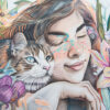 Illustration of a smiling woman with closed eyes resting her head next to a cat, surrounded by colourful flowers and the words Best Friends in the corner. Wall art print available in A1 to A4 sizes.