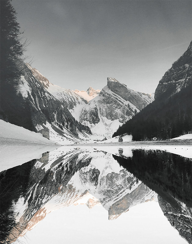 product-image Snow-covered mountains and trees are reflected in the calm, mirror-like surface of Mountain Lake under a clear sky. Nature and landscape poster print available in A1 to A4 sizes.