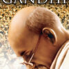 A close-up of a bald man with glasses looking down, with a large crowd in the background and the word Gandhi at the top—an iconic scene from the 1982 Gandhi movie. Movie poster print available in A1 to A4 sizes.