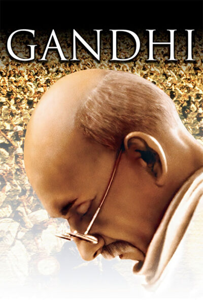 A close-up of a bald man with glasses looking down, with a large crowd in the background and the word Gandhi at the top—an iconic scene from the 1982 Gandhi movie. Movie poster print available in A1 to A4 sizes.