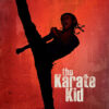 A person in martial arts gear performs a high kick against a red textured background with the movie title The Karate Kid (2010) featured in bold white letters. Movie poster print available in A1 to A4 sizes.