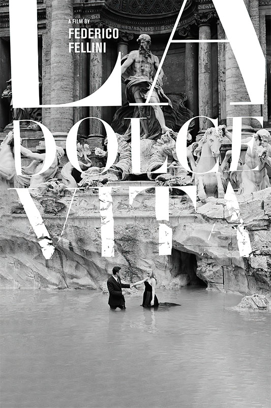 Product-Image_0001_La Dolce Vita.jpg A man in a suit and a woman in a dress stand in the Trevi Fountain; large white text reads La Dolce Vita, with credits for Federico Fellini, director of the iconic 1960 film, above. Movie poster print available in A1 to A4 sizes.