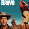Three cowboys stand on rocky terrain under a blue sky with the text Rio Bravo above them; one holds a rifle, another wears a sheriffs badge in this iconic 1959 movie Western film. Movie poster print available in A1 to A4 sizes.