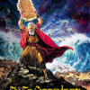 An older man in ancient robes holds stone tablets above his head as stormy clouds and a parted sea surround him. The text reads, The Ten Commandments, capturing the grandeur of the biblical epic 1956 movie. Movie poster print available in A1 to A4 sizes.