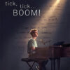 A person sits at a grand piano under a spotlight, with tick tick BOOM text above and handwritten notes on the wall behind them, capturing the electrifying moment from the 2021 musical film. Movie poster print available in A1 to A4 sizes.