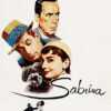 Poster for the film Sabrina 1954 showing Audrey Hepburn with the other main characters, a dog, and the film title in cursive text, with a small dancing couple at the bottom. Movie poster print available in A1 to A4 sizes.