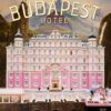 A large, ornate pink hotel labeled The Grand Budapest Hotel stands in front of a mountainous backdrop with a deer statue on a peak, capturing the whimsical charm of the 2014 film. Movie poster print available in A1 to A4 sizes.