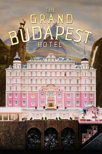 A large, ornate pink hotel labeled The Grand Budapest Hotel stands in front of a mountainous backdrop with a deer statue on a peak, capturing the whimsical charm of the 2014 film. Movie poster print available in A1 to A4 sizes.