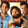Three men and a baby stand in front of a lit HANGOVER sign, looking disheveled and confused, echoing the chaos of The Hangover 2009 movie. Movie poster print available in A1 to A4 sizes.