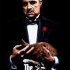 A man in a tuxedo with a red rose on his lapel holds a brown cat in his hands. Below him, text reads The Godfather, referencing the iconic 1972 film, with a puppet hand logo. Movie poster print available in A1 to A4 sizes.
