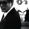 A man in a suit and glasses stands in the foreground; in the background, two blurred figures hold hands. The stylized text 8 1/2 appears at the top right. Movie poster print available in A1 to A4 sizes.