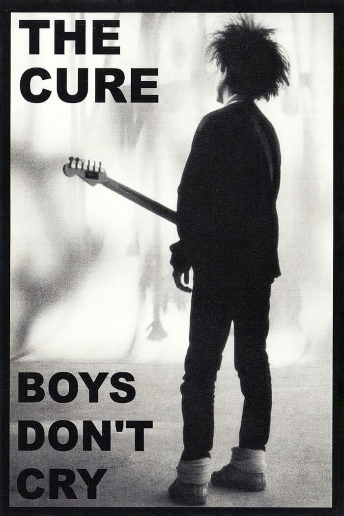 product-image Black-and-white photo of a person with a guitar standing in profile, with bold text The Cure Boys Dont Cry—a striking music poster celebrating the iconic band and their classic hit. A1 to A4 poster print.