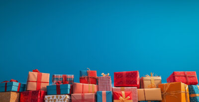 A row of assorted Gift Boxes in various colours and patterns, arranged against a plain blue background—perfect for a Customizable Poster where you can Add Your Own Text. Prints available in A1 to A4 sizes.