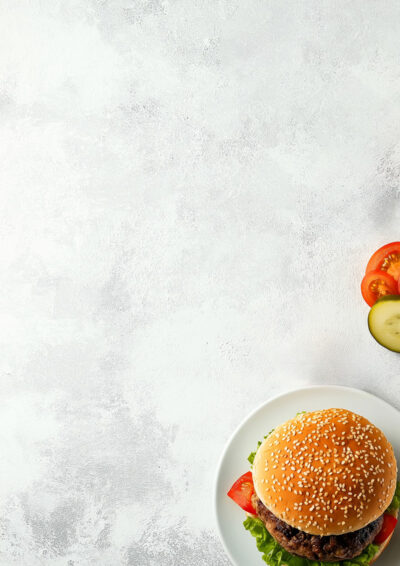 A sesame seed hamburger on a white plate sits in the lower right corner, with sliced tomato and cucumber on the side—perfect as a customizable burger menu background where you can add your own text against a light textured backdrop. Customizable print available in A1 to A4 sizes.
